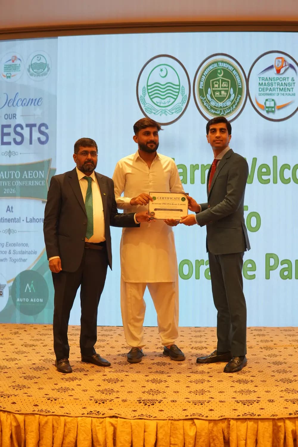 An Auto Aeon franchise partner receiving their certificate on stage