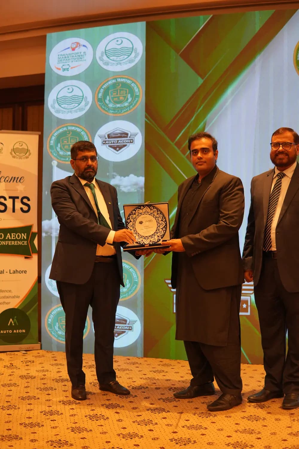 A commemorative shield presented on stage at the conference